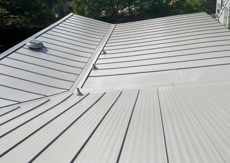 Solar attic fan installed on a metal roof for Roof Ventilation in Pompano Beach