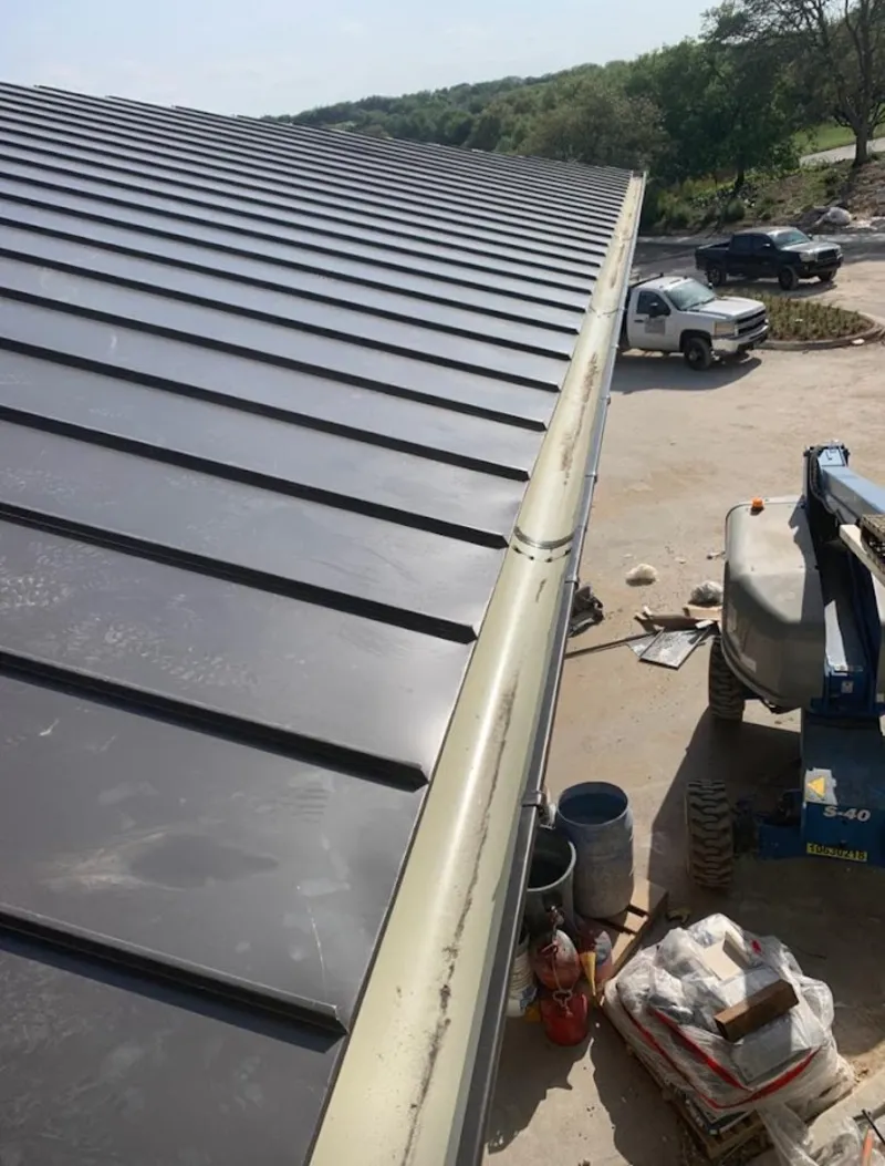 Standing seam panel and gutter detail on a metal roofing jobsite in Pompano Beach